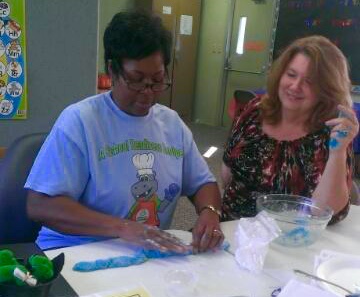 Alma Carnes, Lowndes Parent Educator, and Joanne Shum, Coordinator, enjoying the math learning using the play dough.
